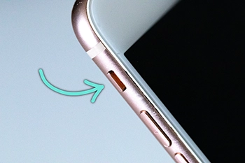 The iPhone mute switch in the "silent" position